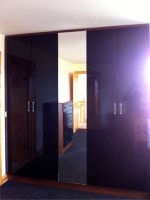 High gloss black sliding wardrobe with mirror - fitted by Barrett Kitchens, Letterkenny, Co. Donegal, Ireland
