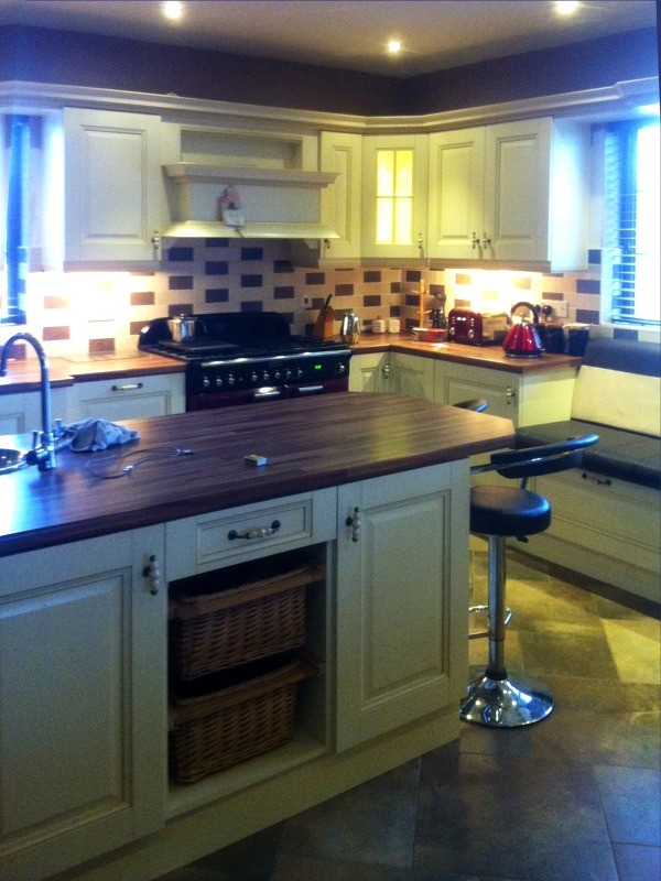 Cream hand-painted in frame kitchen with central sink unit designed and fitted by Barrett Kitchens, County Donegal, Ireland Cream hand-painted in frame kitchen with central sink unit designed and fitted by Barrett Kitchens, County Donegal, Ireland