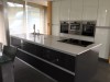 Gloss white modern kitchen with dark grey central unit  - designed and fitted by Barret Kitchens, Letterkenny, Co. Donegal, Ireland