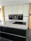 Gloss white modern kitchen with dark grey central unit - designed and fitted by Barret Kitchens, Letterkenny, Co. Donegal, Ireland