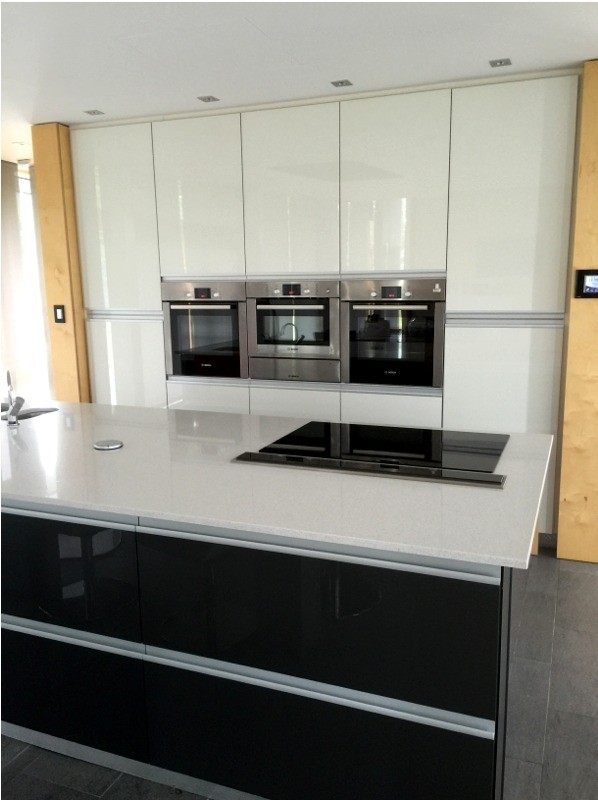 Gloss white modern kitchen with dark grey central unit - designed and fitted by Barret Kitchens, Letterkenny, Co. Donegal, Ireland Gloss white modern kitchen with dark grey central unit - designed and fitted by Barret Kitchens, Letterkenny, Co. Donegal, Ireland