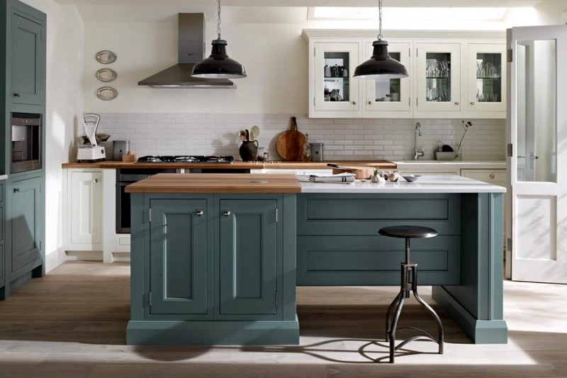 Green and white hand-painted in frame kitchen showing central island / breakfast bar, hob & cooker and fitted cupboard base and wall units designed and fitted by Barrett Kitchens, Milford, Letterkenny, Co. Donegal, Ireland