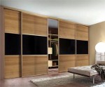 Large sliding wardrobe unit with wood doors - bedroom units designed and fitted by Barrett Kitchens, Donegal, Ireland