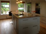 Hand painted in frame kitchen with central unit and granite tops, designed and fitted by Barrett Kitchens, Co. Donegal, Ireland