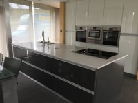 Gloss graphite island with white Quartz worktop