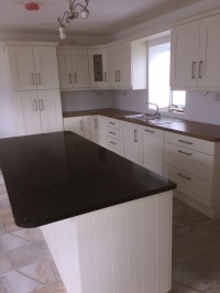 Albany Ivory painted kitchen with walnut worktop on main kitchen and Quartz on island